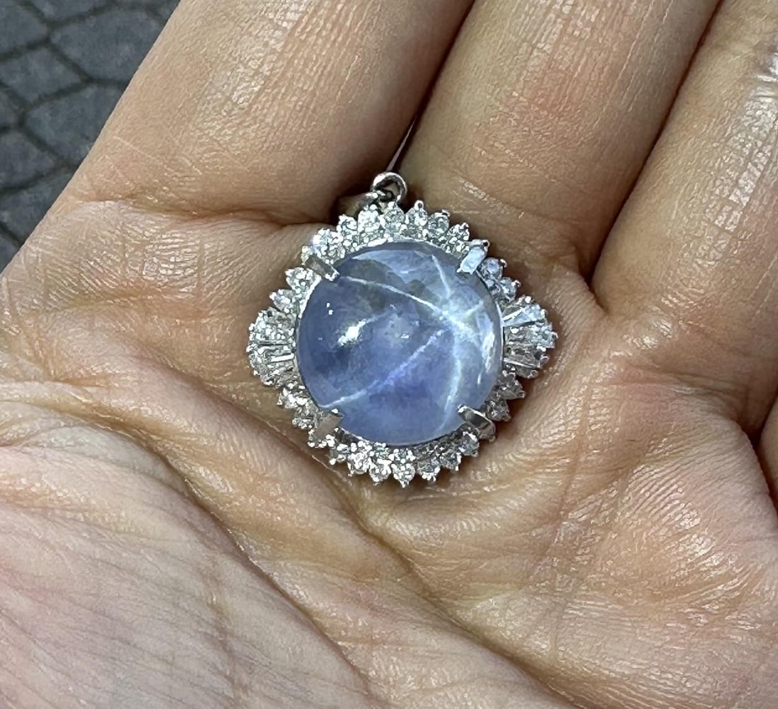 Vintage GIA Certified 18.85ct Star Sapphire Diamond Halo Pendant in Platinum: Vintage GIA Certified 18.85ct Star Sapphire Diamond Halo Pendant in Platinum This exquisite vintage pendant features a stunning 17.49ct round cabochon star sapphire, prong set in solid platinum. The s