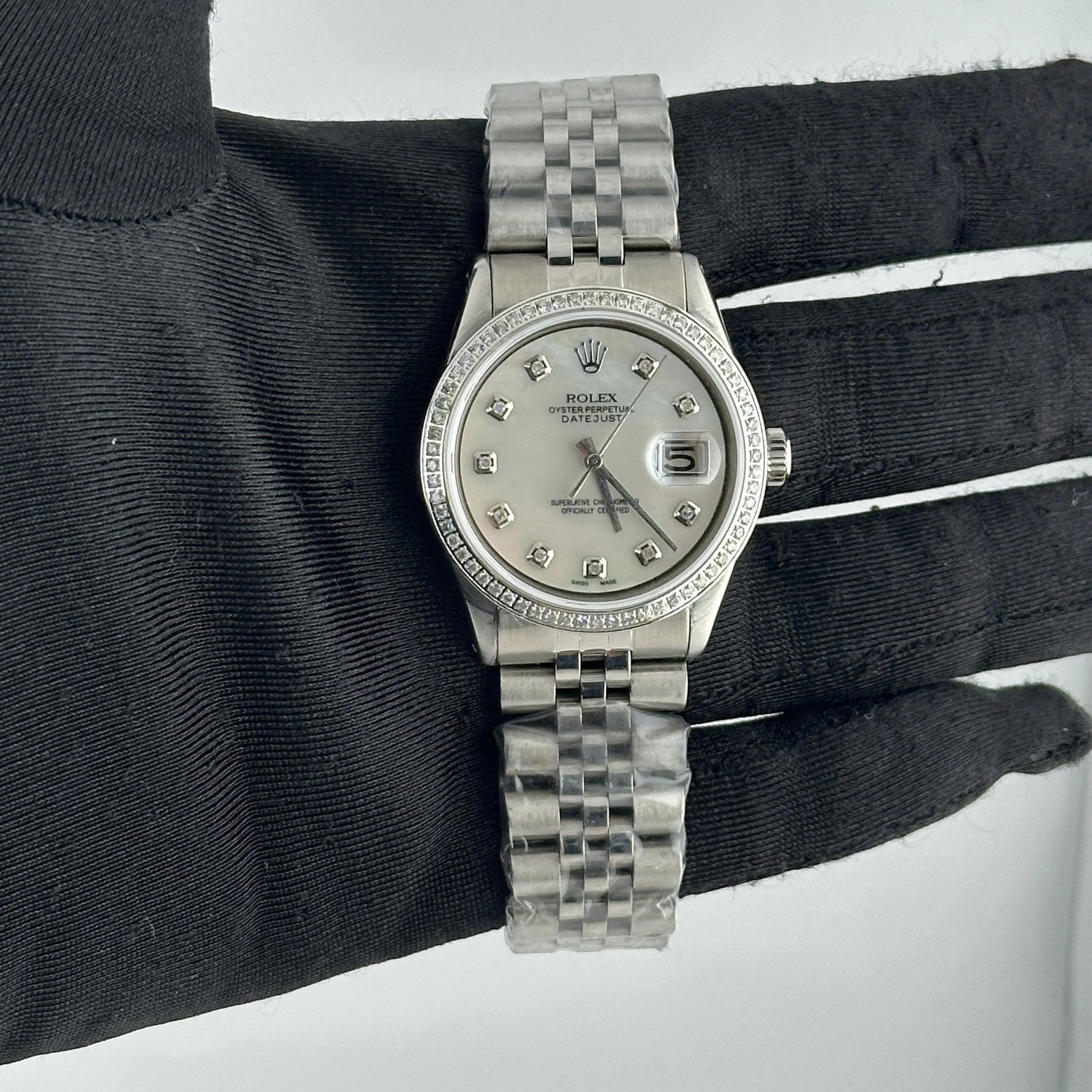 Aftermarket Diamond MOP Dial Jubilee Bracelet Rolex Datejust Ref 1603: Aftermarket Diamond MOP Dial Jubilee Bracelet Rolex Datejust Ref 1603 This men's Rolex Datejust features an aftermarket white mother-of-pearl dial set with diamonds and a pave diamond bezel. It is equ