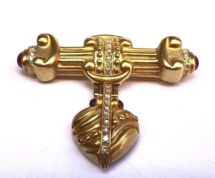 Dorris Panos 18K Gold Diamond Ruby Signed Brooch 1993: Dorris Panos 18K Gold Diamond Ruby Signed Brooch 1993 Discover the elegance of this stunning brooch, crafted by Dorris Panos in 1993. Made from 18K yellow gold, this piece features exquisite diamond a