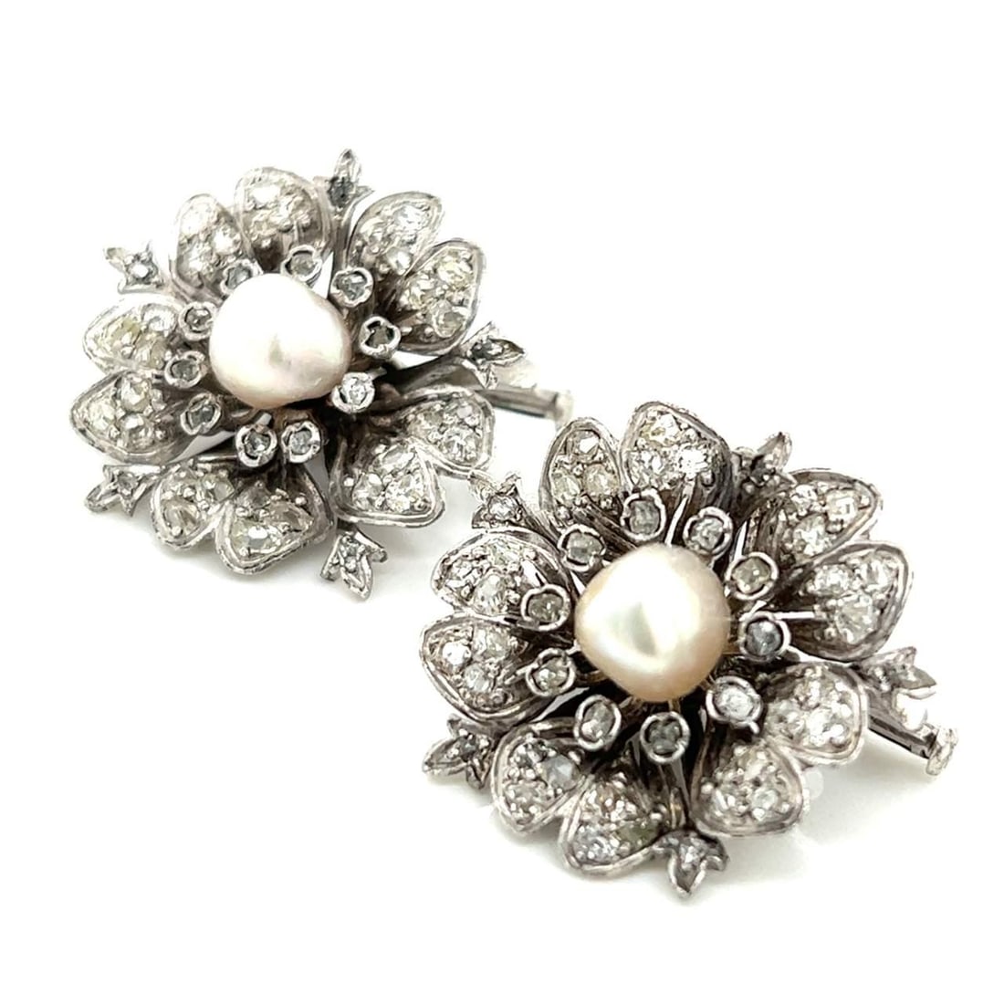Victorian Platinum Flower Brooches with Natural Pearls and Diamonds: Victorian Platinum Flower Brooches with Natural Pearls and Diamonds This exquisite pair of Victorian flower brooches is crafted in platinum and adorned with natural pearls and Old European-cut diamond
