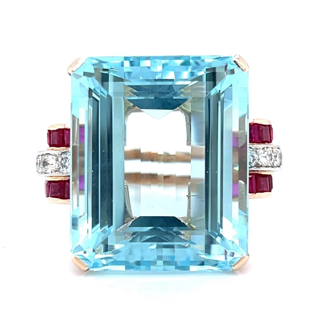 Retro 14K Rose Gold Ring with 50 Ct Aquamarine and Burma Rubies: Retro 14K Rose Gold Ring with 50 Ct Aquamarine and Burma Rubies This exquisite Retro ring features a stunning design crafted in 14K rose gold. It showcases an impressive approximately 50.00 ct aquamar