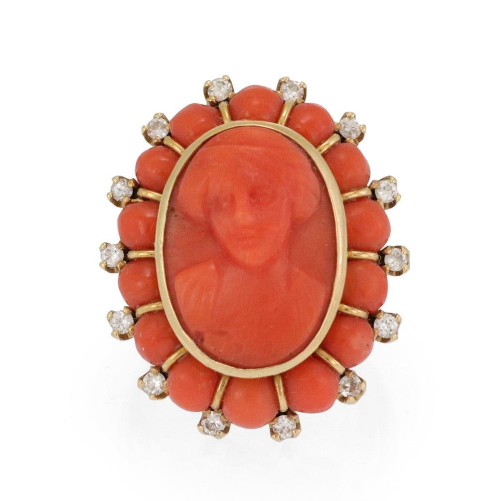 Vintage 18k Gold Coral Cameo Ring with Diamonds: Vintage 18k Gold Coral Cameo Ring with Diamonds This exquisite vintage ring showcases a beautifully carved coral cameo of a woman, elegantly set in a polished 18k yellow gold bezel frame. The ring fea