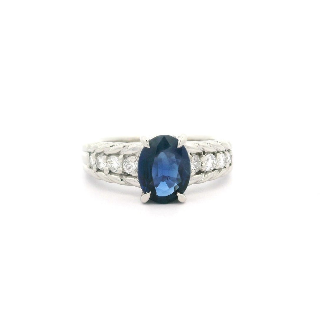 Platinum 1.55ctw Oval Blue Sapphire & Diamond Cocktail Ring: Platinum 1.55ctw Oval Blue Sapphire & Diamond Cocktail Ring This exquisite cocktail ring features a stunning oval cut natural blue sapphire that showcases a velvety color, measuring 8x6.1mm and weighi