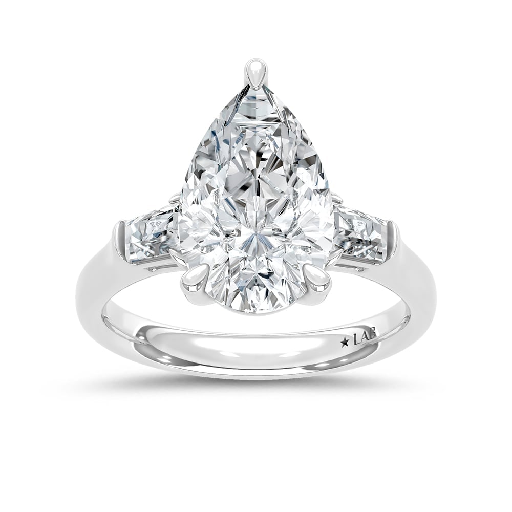 14K White Gold Lab Grown Diamond 4 1/4 Ct.Tw. Pear and Tapper Three Stone Engagement Ring: 14K White Gold Lab Grown Diamond 4 1/4 Ct.Tw. Pear and Tapper Three Stone Engagement Ring This stunning three-stone ring features a sparkling 4 CT Pear Center diamond with two shimmering side diamonds