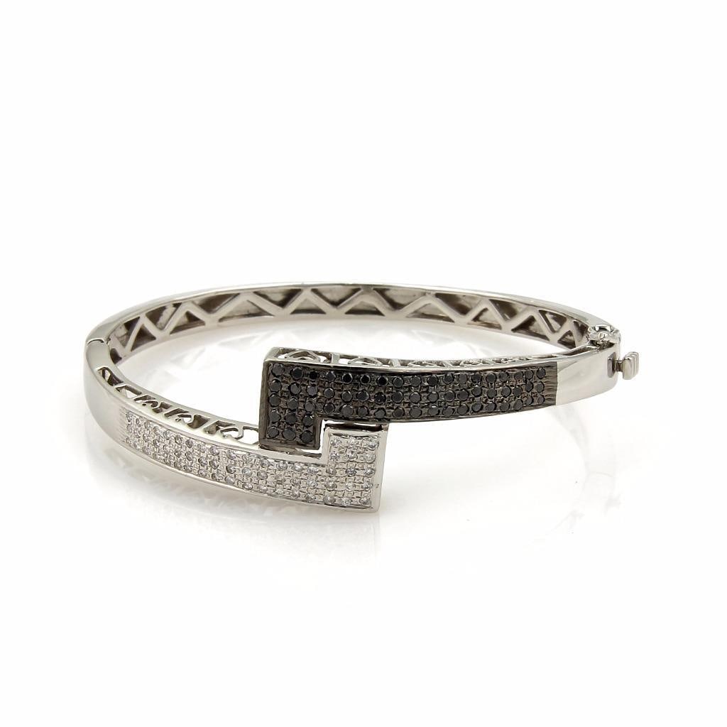 Elegant 14k White Gold Black and White Diamond Bangle Bracelet: Elegant 14k White Gold Black and White Diamond Bangle Bracelet This stunning black and white diamond bracelet features a striking design crafted from solid 14k white gold with a high polished finish.
