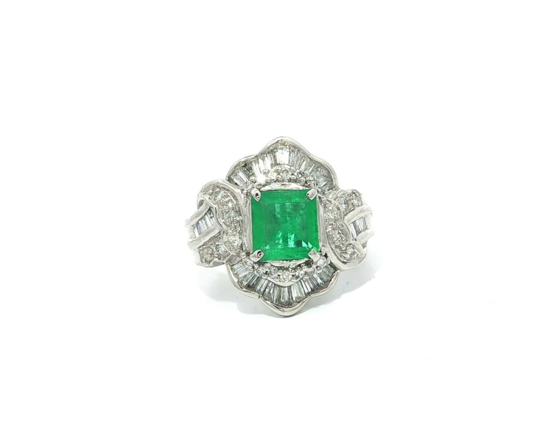 Platinum Wide Band Ring with 1.8ctw Square Emerald and Baguette Diamonds: Platinum Wide Band Ring with 1.8ctw Square Emerald and Baguette Diamonds This stunning cocktail ring features a vibrant natural emerald, square step cut, prong set in solid .900 platinum. The main sto