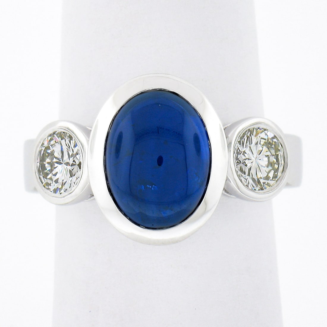 Gubelin Certified Platinum 4.99ctw Oval Cabochon Sapphire Diamond 3 Stone Ring: Gubelin Certified Platinum 4.99ctw Oval Cabochon Sapphire Diamond 3 Stone Ring This exquisite three-stone ring showcases a stunning Gubelin certified natural sapphire at its center, beautifully bezel