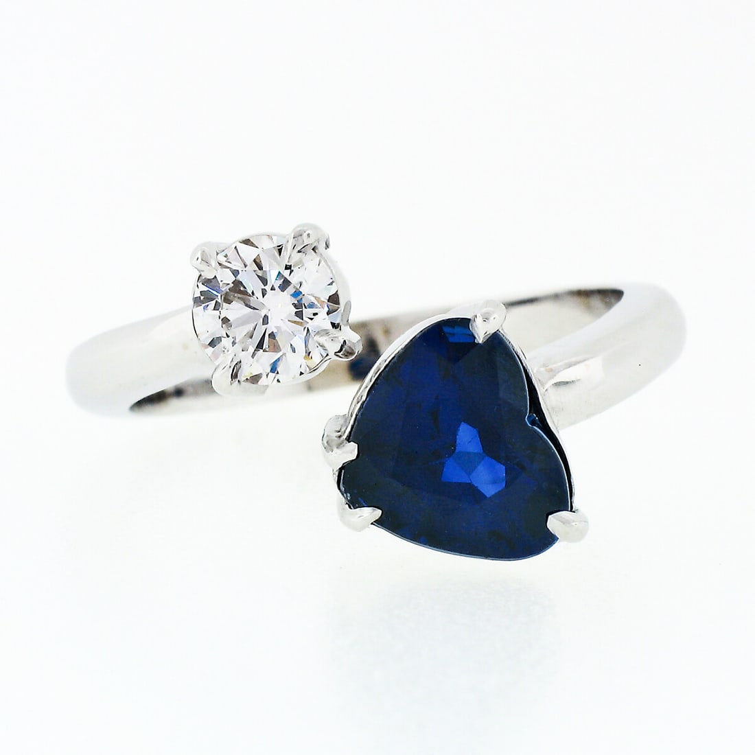 New 18K White Gold GIA Certified Heart Blue Sapphire Diamond Bypass Ring: New 18K White Gold GIA Certified Heart Blue Sapphire Diamond Bypass Ring This exquisite bypass ring is crafted from solid 18K white gold and features a stunning 2.29 carat GIA certified heart-shaped b