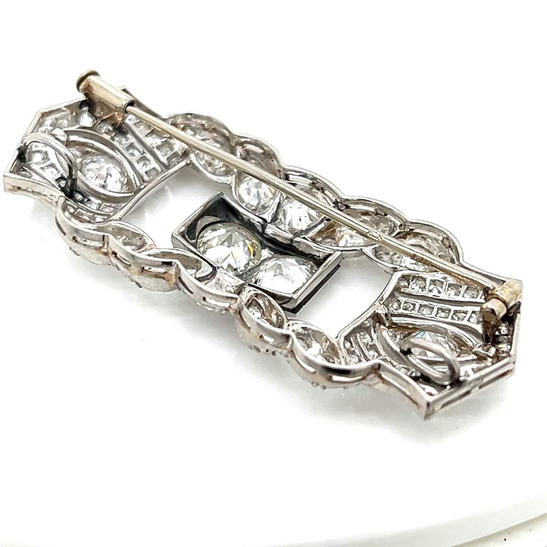 Art Deco Platinum 7.80 Ct Diamond Brooch with F-H Color: Art Deco Platinum 7.80 Ct Diamond Brooch with F-H Color This exquisite Art Deco brooch is crafted in platinum and features a stunning total diamond weight of 7.80 ct. The brooch showcases two larger d
