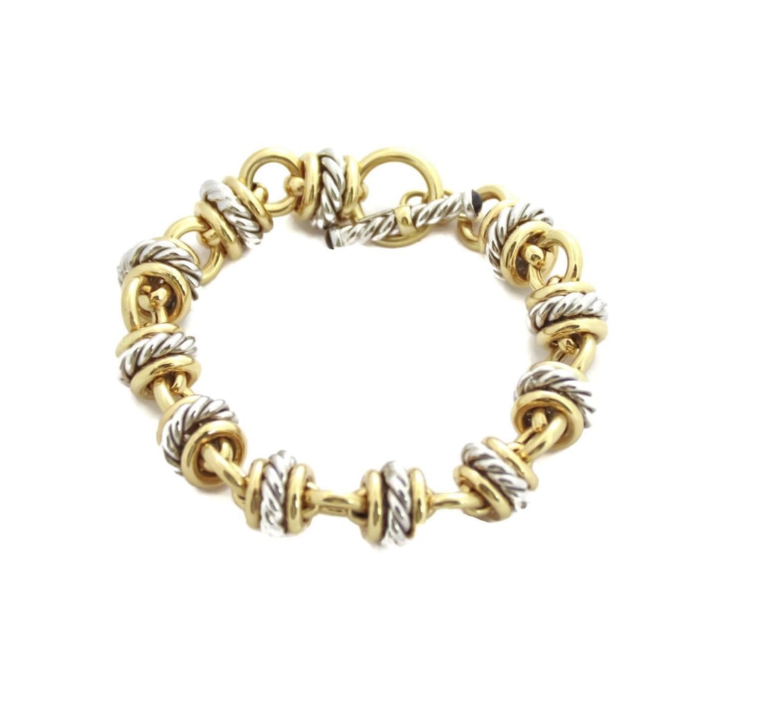 14k Gold Italy Toggle Bracelet with Cable Link Design: 14k Gold Italy Toggle Bracelet with Cable Link Design This exquisite bracelet combines elegance and charm, featuring a unique design crafted from 14k yellow and white gold. The bracelet showcases alte