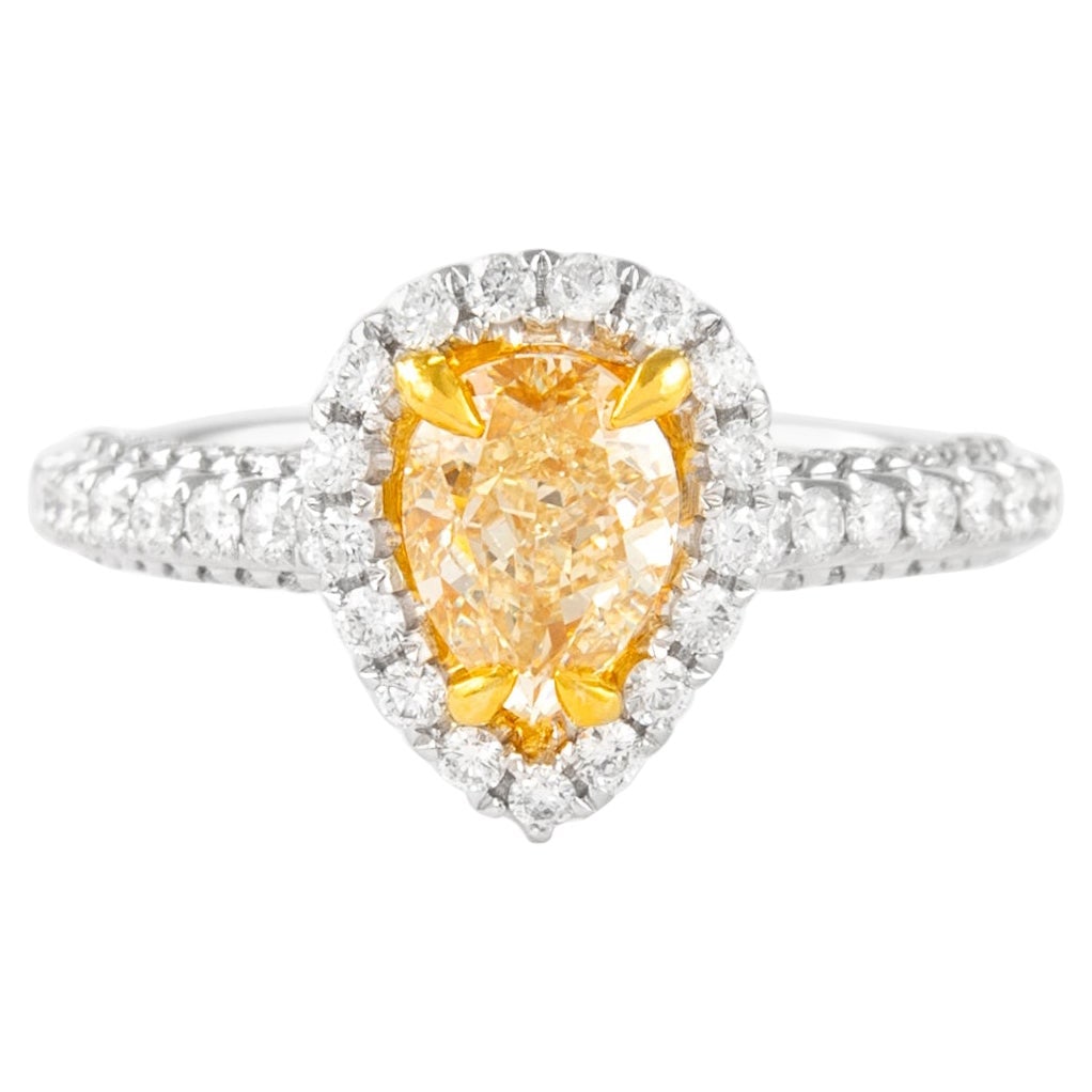 1.01ct Fancy Intense Yellow Diamond Halo Ring 18k: 1.01ct Fancy Intense Yellow Diamond Halo Ring 18k This exquisite 1.01ct Fancy Intense Yellow Pear Diamond Ring features a stunning pear cut diamond of SI1 clarity, set within a contemporary halo desig