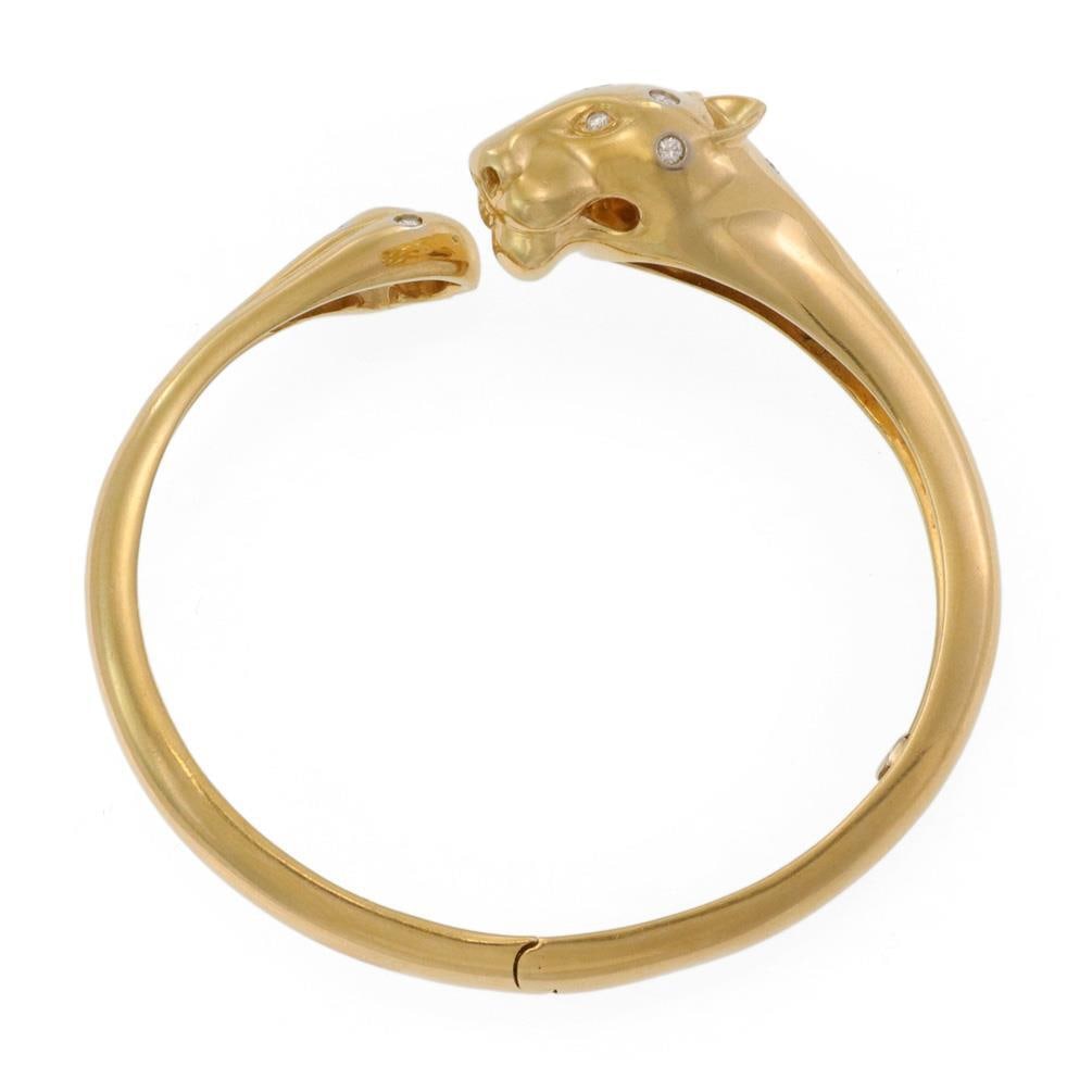 18k Yellow Gold Panther Bypass Cuff Bangle with Diamonds: 18k Yellow Gold Panther Bypass Cuff Bangle with Diamonds This stunning panther bypass cuff bangle is beautifully crafted from 18k yellow gold. The bracelet features an intricately designed panther hea