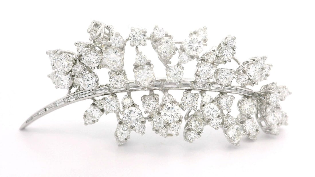 Vintage 7.50ctw Diamond Floral Brooch in Platinum and 14k White Gold: Vintage 7.50ctw Diamond Floral Brooch in Platinum and 14k White Gold This exquisite vintage brooch showcases a stunning cluster design with a combination of 18 baguette-cut diamonds and 102 round bril