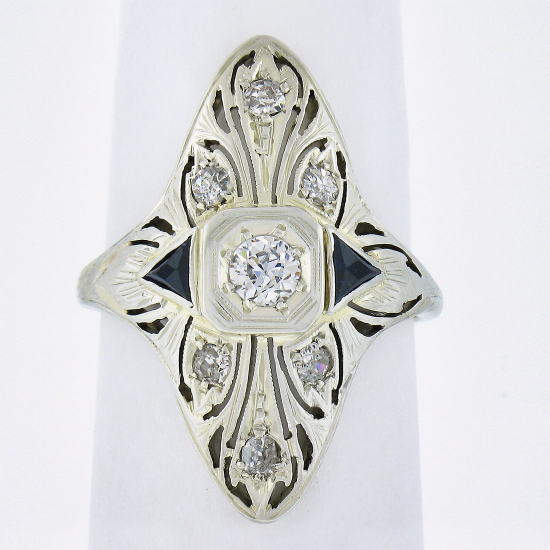 Antique Art Deco 18K White Gold 0.32ctw Diamond Sapphire Navette Ring: Antique Art Deco 18K White Gold 0.32ctw Diamond Sapphire Navette Ring This exquisite Antique Art Deco ring features a stunning navette shape crafted from solid 18K white gold. The ring showcases a tot
