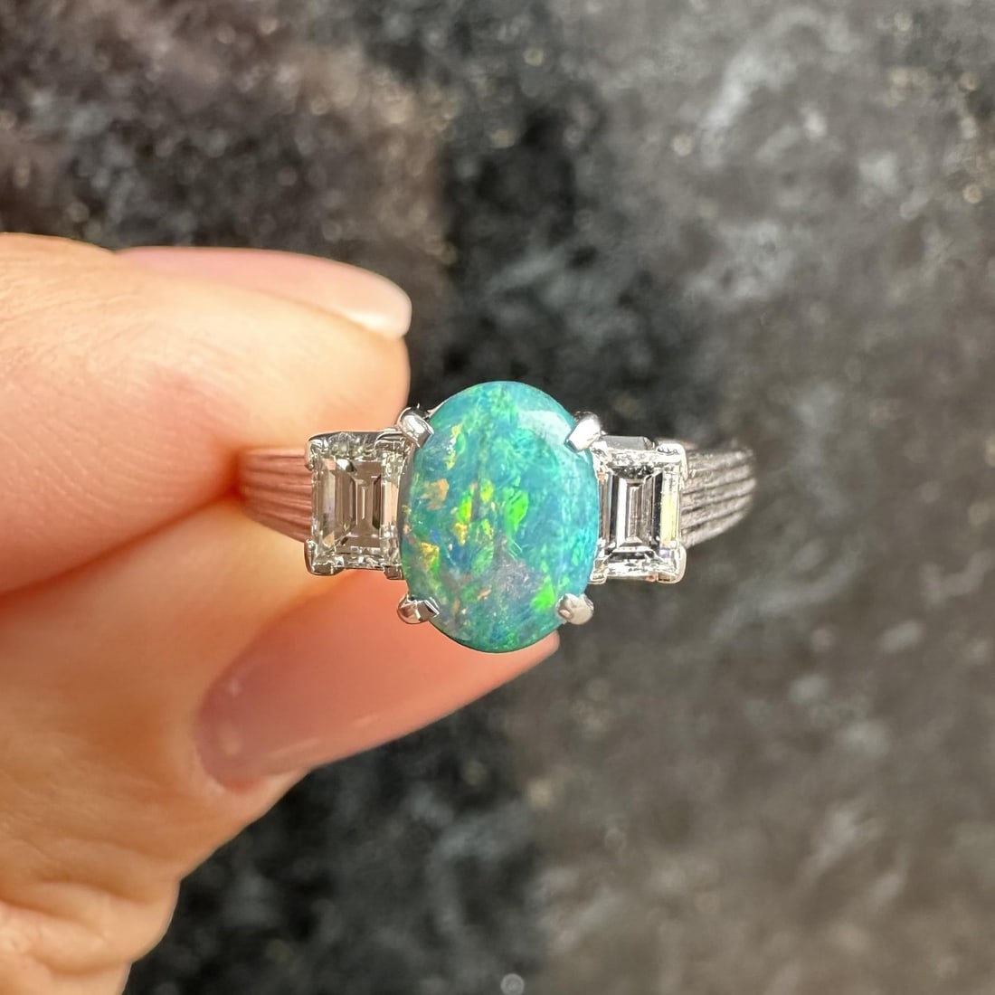 Vintage Platinum 1.43ct GIA Oval Boulder Opal Ring with Diamond Accents: Vintage Platinum 1.43ct GIA Oval Boulder Opal Ring with Diamond Accents This stunning vintage cocktail ring showcases a 1.43ctw GIA certified oval boulder opal, beautifully complemented by two rectang
