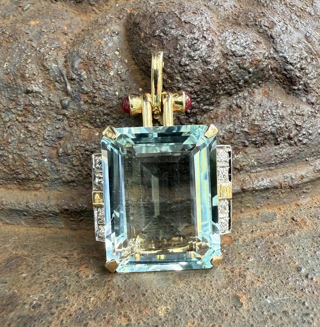 Vintage Retro 34.2ct Aquamarine Diamond Ruby Pendant in Gold: Vintage Retro 34.2ct Aquamarine Diamond Ruby Pendant in Gold This stunning vintage retro enhancer pendant showcases a breathtaking natural aquamarine centerpiece, elegantly set in solid yellow gold wi