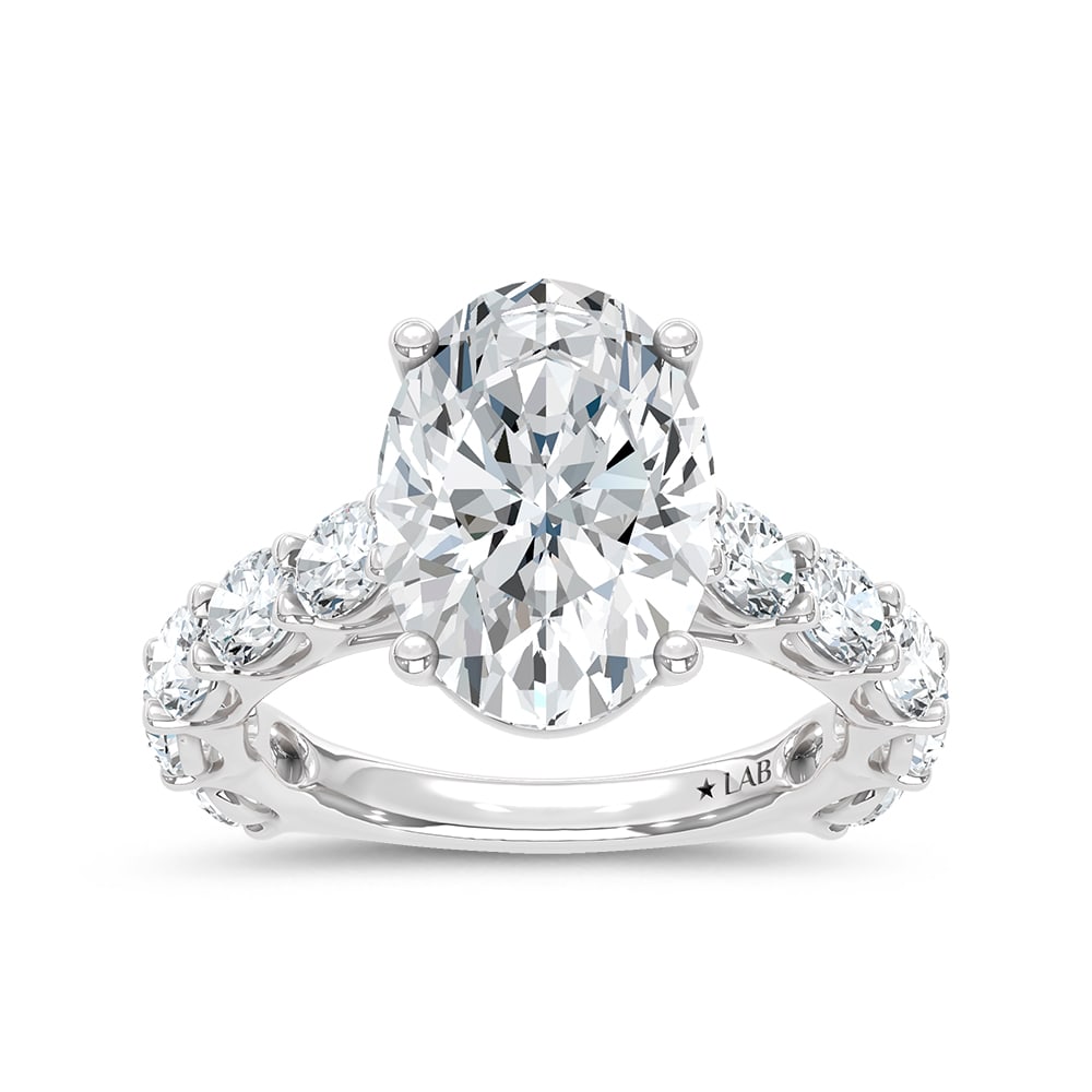 14K White Gold Lab Grown Diamond 7 Ct.Tw. Oval Shape Engagement Ring: 14K White Gold Lab Grown Diamond 7 Ct.Tw. Oval Shape Engagement Ring This elegant diamond engagement ring crafted in 14k White gold, features a Oval -cut center stone of 5 ct that creates a stunning s
