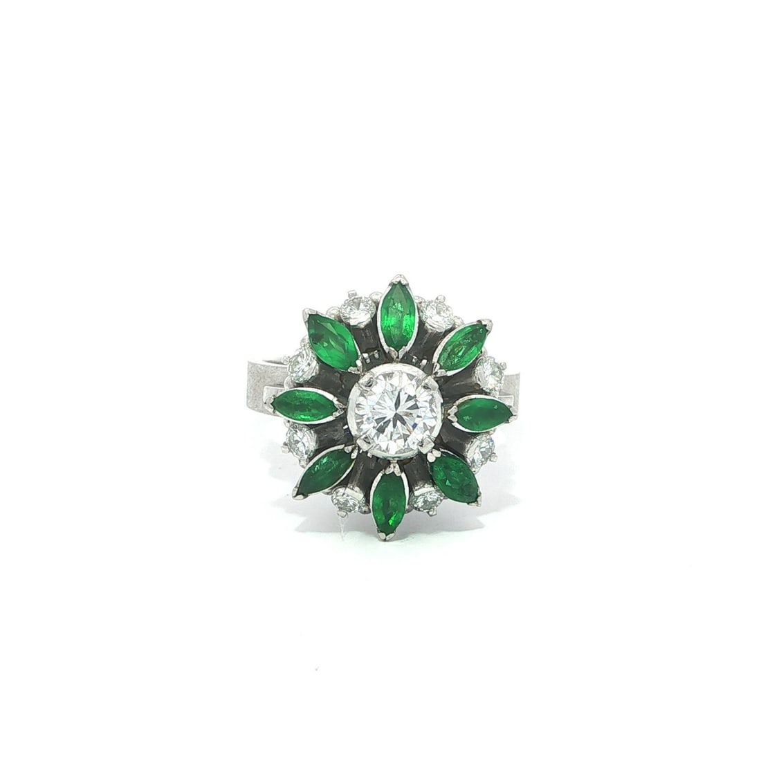 Platinum 1.41ctw Diamond Emerald Flower Cocktail Ring: Platinum 1.41ctw Diamond Emerald Flower Cocktail Ring This exquisite cocktail ring features a stunning floral design adorned with vivid green emeralds and brilliant white diamonds. Crafted in solid pl