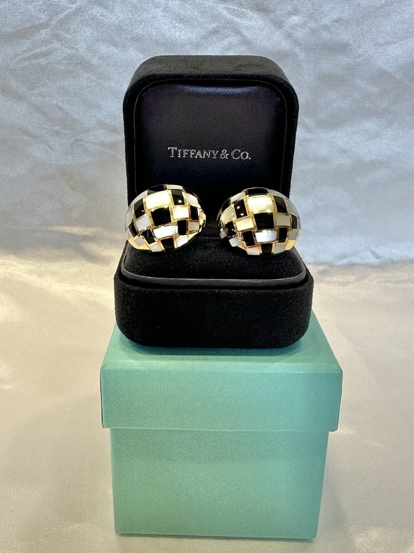 Tiffany & Co 18K Gold Mother of Pearl Onyx Cuff Stud Earrings with Box: Tiffany & Co 18K Gold Mother of Pearl Onyx Cuff Stud Earrings with Box This exquisite pair of Tiffany & Co. earrings features a stunning combination of 18k yellow gold, mother of pearl, and black onyx