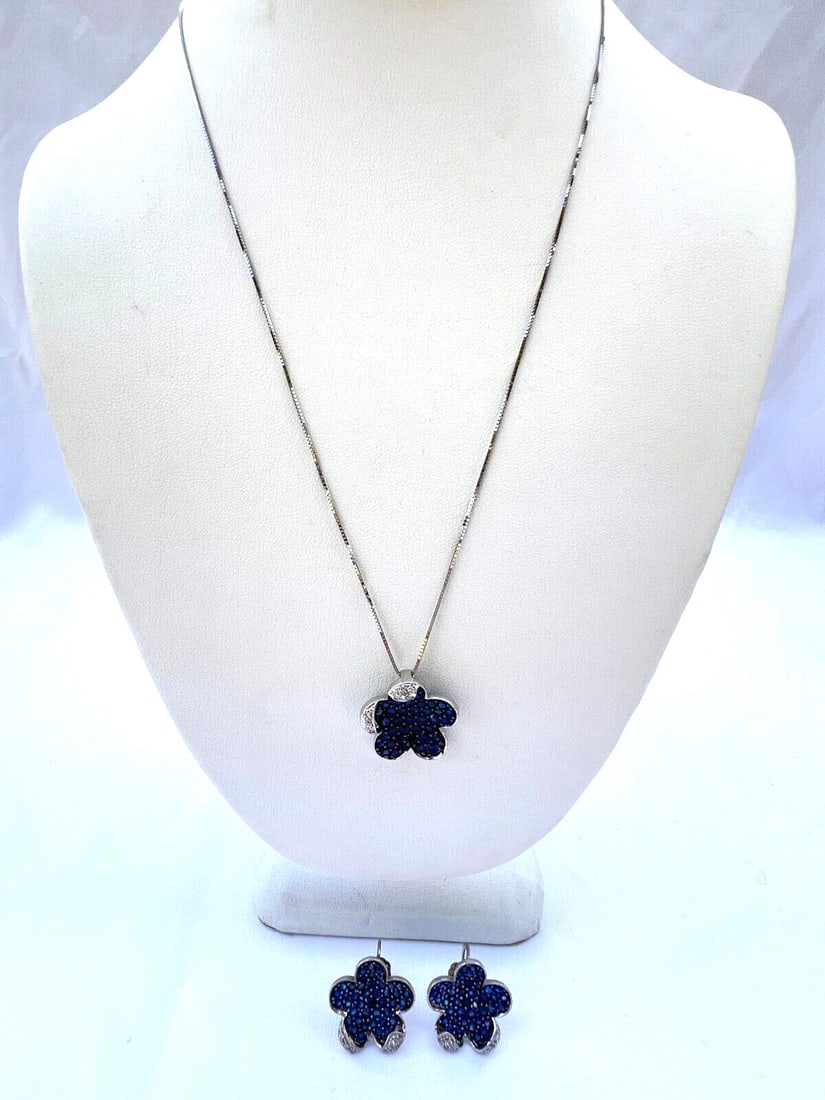 18K White Gold Diamond Sapphire Necklace and Earring Set: 18K White Gold Diamond Sapphire Necklace and Earring Set This exquisite set features an 18K white gold necklace and matching pair of earrings, showcasing a stunning combination of diamonds and sapphir