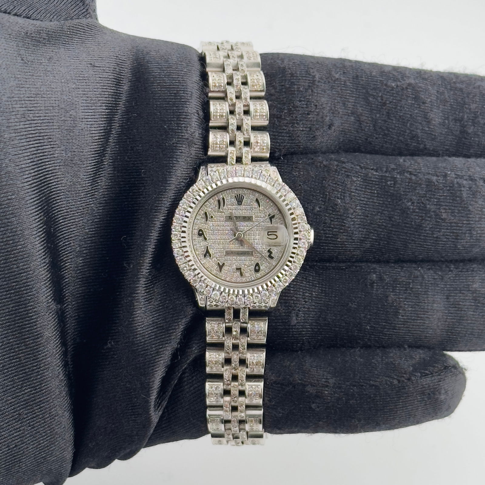 Ladies Rolex Datejust 6517 Aftermarket Iced Out Arabic Dial Jubilee Bracelet: Ladies Rolex Datejust 6517 Aftermarket Iced Out Arabic Dial Jubilee Bracelet This ladies Rolex Datejust features an iced out Arabic dial, a prong-set bezel, and an Aftermarket Jubilee iced out bracele