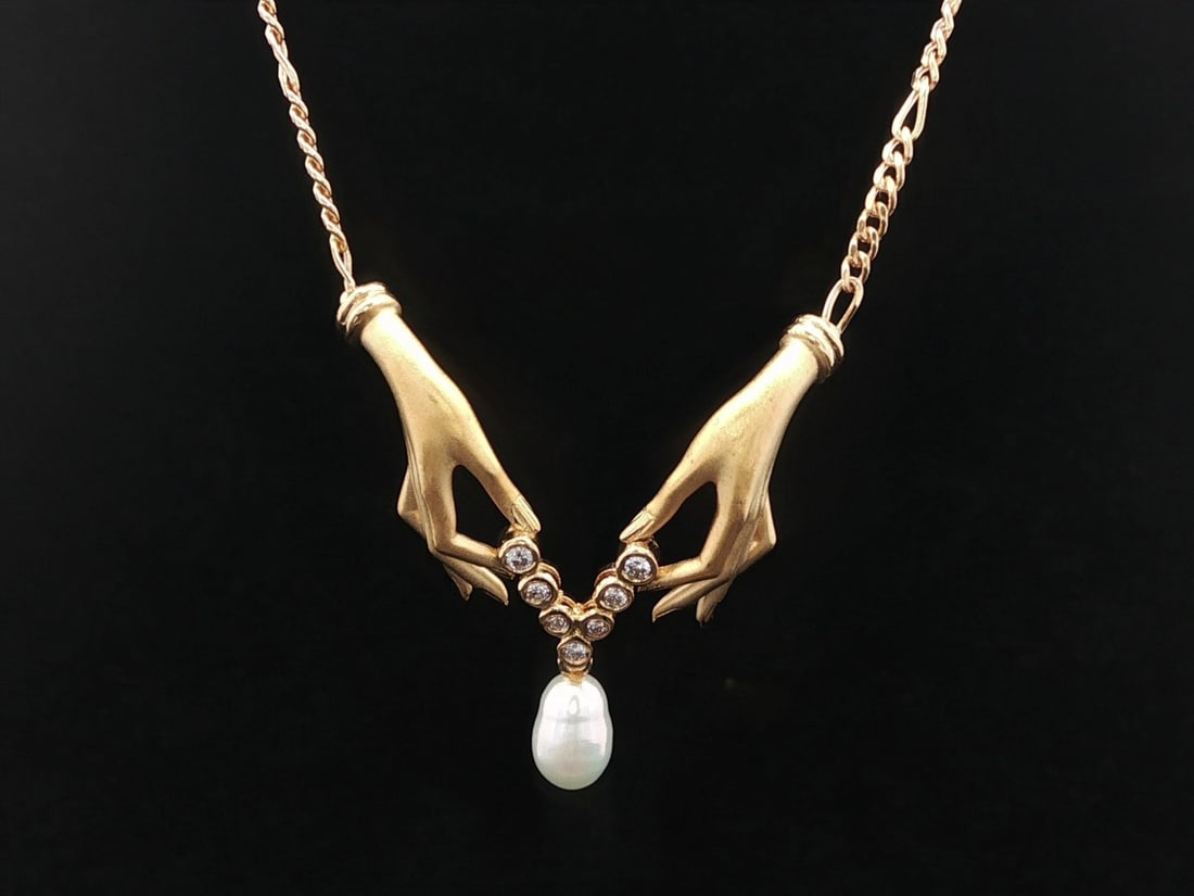 18k Yellow Gold Happy Hands Pendant Necklace with Diamonds and Pearl by Carrera y Carrera: 18k Yellow Gold Happy Hands Pendant Necklace with Diamonds and Pearl by Carrera y Carrera This Carrera y Carrera Happy Hands Bonadea dangle pendant necklace features a baroque-shaped genuine cultured