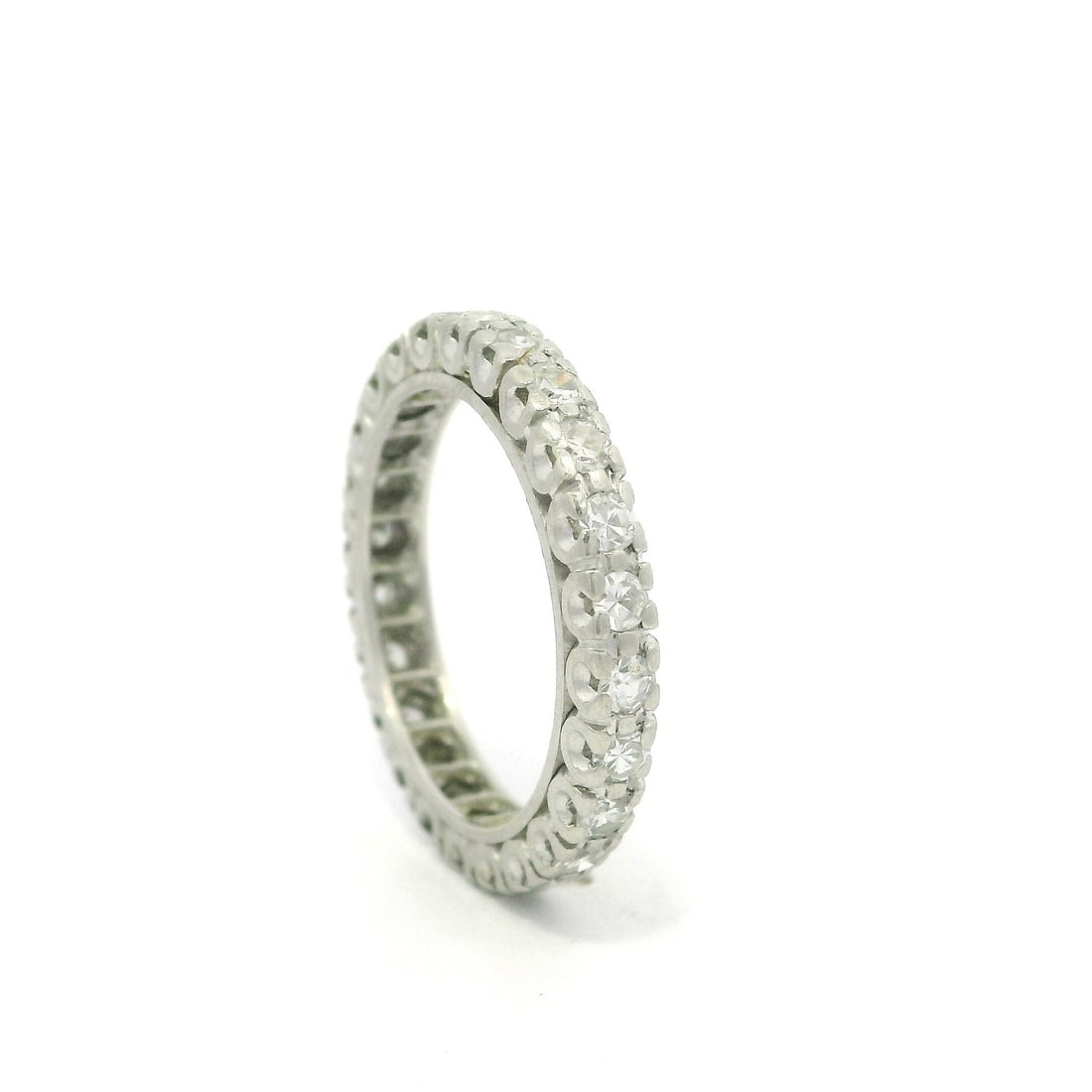 Vintage Mid Century Platinum 0.60ctw Diamond Eternity Band Ring: Vintage Mid Century Platinum 0.60ctw Diamond Eternity Band Ring This exquisite vintage mid-century eternity band ring is crafted in solid platinum and features 24 natural genuine single cut diamonds,