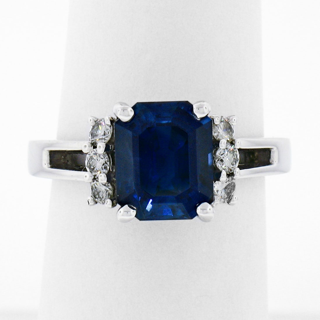 Kurt Wayne 18K White Gold 3.36ct AGL Sapphire Diamond Ring: Kurt Wayne 18K White Gold 3.36ct AGL Sapphire Diamond Ring This exquisite ring by Kurt Wayne features a stunning 3.36ct emerald cut sapphire, certified by AGL, set in solid 18K white gold. The sapphir