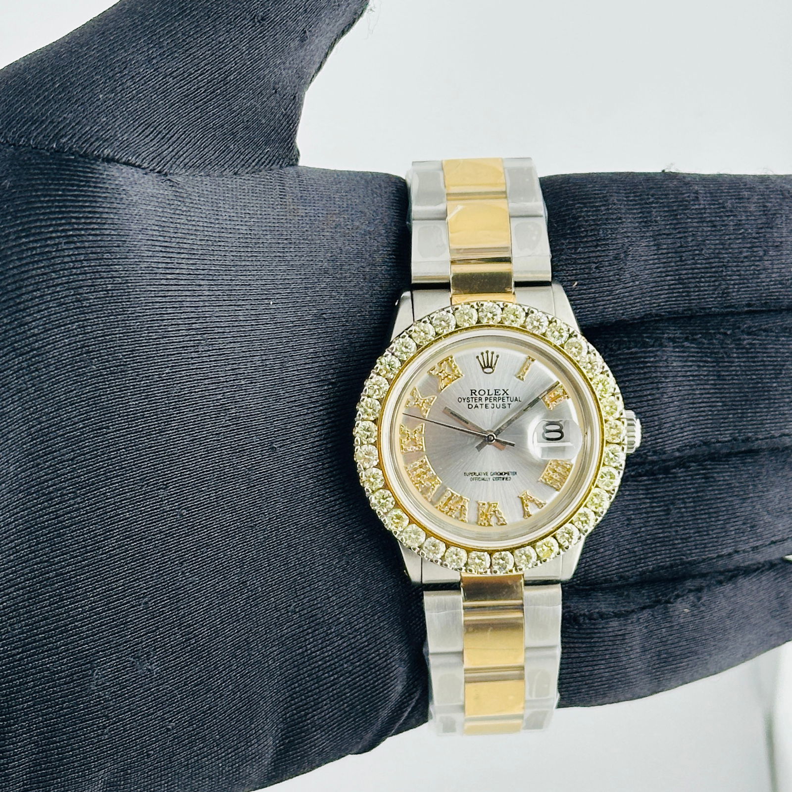 Rolex Datejust 1601 Aftermarket Silver Roman Diamond Dial Oyster Bracelet: Rolex Datejust 1601 Aftermarket Silver Roman Diamond Dial Oyster Bracelet This Rolex Datejust features an aftermarket silver Roman diamond dial, complemented by a prong-plated diamond bezel. It is equ
