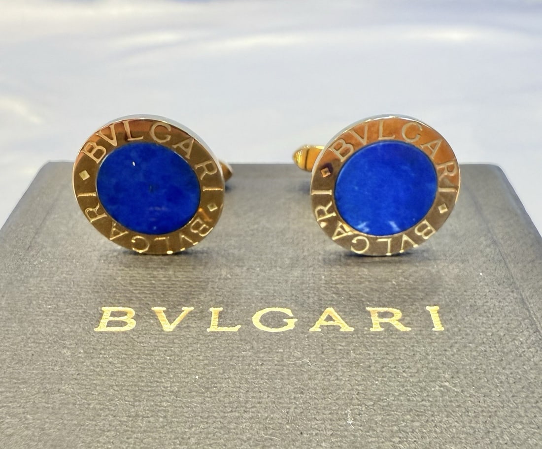 Bvlgari 18K Yellow Gold Lapis Cufflinks with Box: Bvlgari 18K Yellow Gold Lapis Cufflinks with Box Elevate your formal attire with this exquisite pair of Bvlgari cufflinks. Crafted from luxurious 18k yellow gold, these cufflinks feature stunning lapi