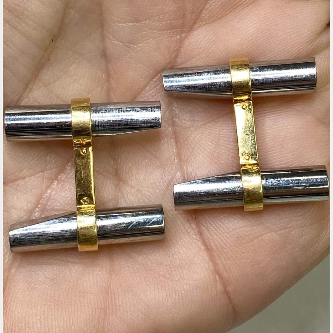 Cartier 18K Yellow Gold and Stainless Steel Cufflinks: Cartier 18K Yellow Gold and Stainless Steel Cufflinks These exquisite Cartier cufflinks are crafted from a luxurious combination of 18K yellow gold and stainless steel, offering a sophisticated touch