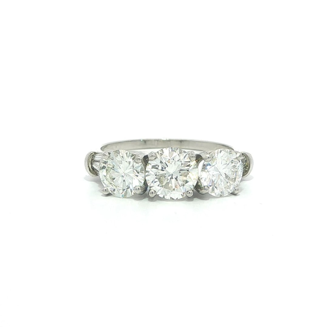 Platinum Three Stone Band with 3.02ctw GIA Certified Round and Baguette Diamonds: Platinum Three Stone Band with 3.02ctw GIA Certified Round and Baguette Diamonds This vintage three-stone cocktail ring features a total of 3.02 carats of natural diamonds set in solid platinum. The c