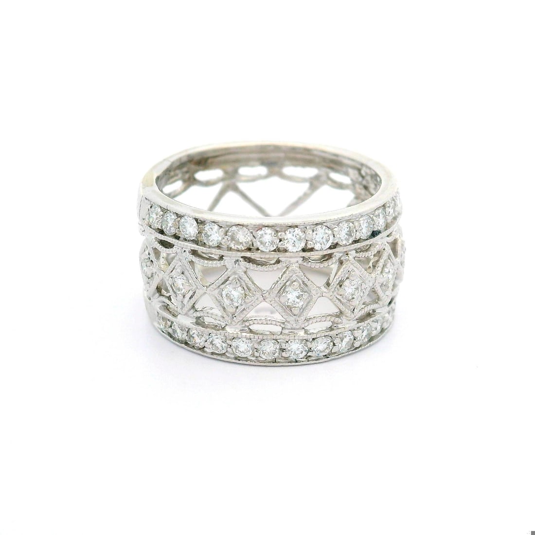 18k White Gold 0.65ctw Diamond Miligrain Etched Wide Band Ring: 18k White Gold 0.65ctw Diamond Miligrain Etched Wide Band Ring This exquisite 18k white gold band ring features a stunning wide open work design embellished with milgrain etching. It is adorned with 4