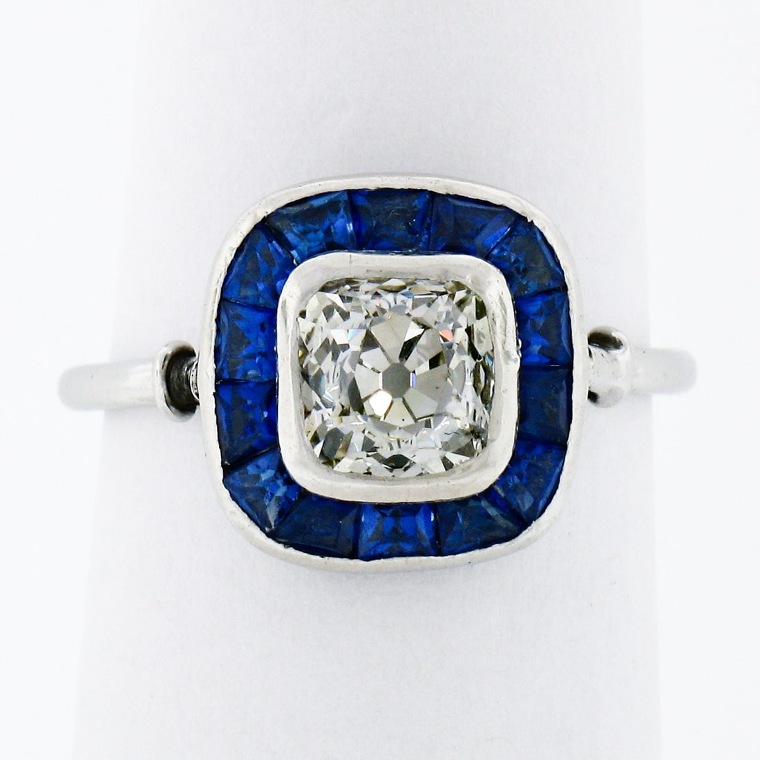 Antique Art Deco Platinum Cushion Diamond Sapphire Halo Ring 1.85ctw: Antique Art Deco Platinum Cushion Diamond Sapphire Halo Ring 1.85ctw This exquisite Antique Art Deco Platinum Bezel Old Mine Cushion Diamond & Sapphire Halo Ring showcases timeless elegance and crafts