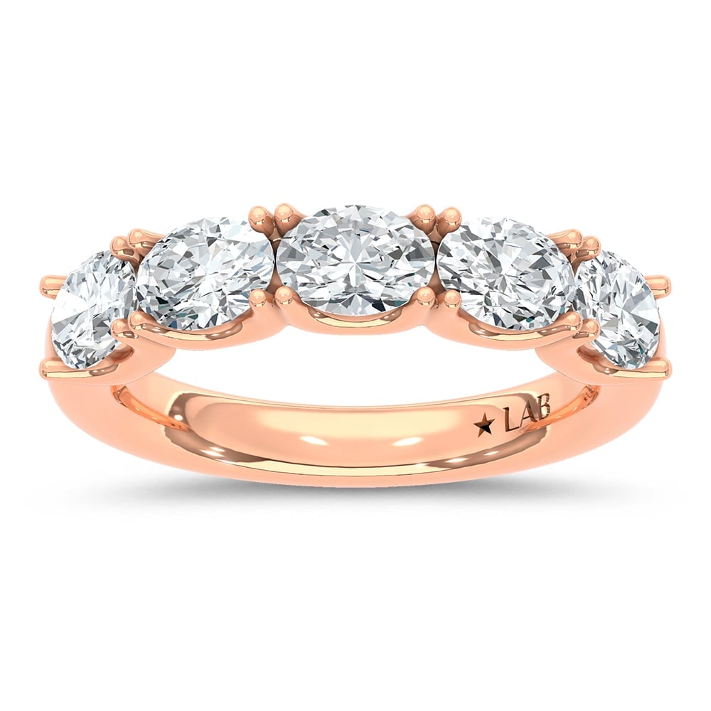 14K Rose Gold Lab Grown Diamond 2 Ct.Tw. Oval Shape East West Wedding Band: 14K Rose Gold Lab Grown Diamond 2 Ct.Tw. Oval Shape East West Wedding Band Make a statement with this unique 14K Rose gold wedding band, featuring 2 carats total weight of lab-grown diamonds set in an