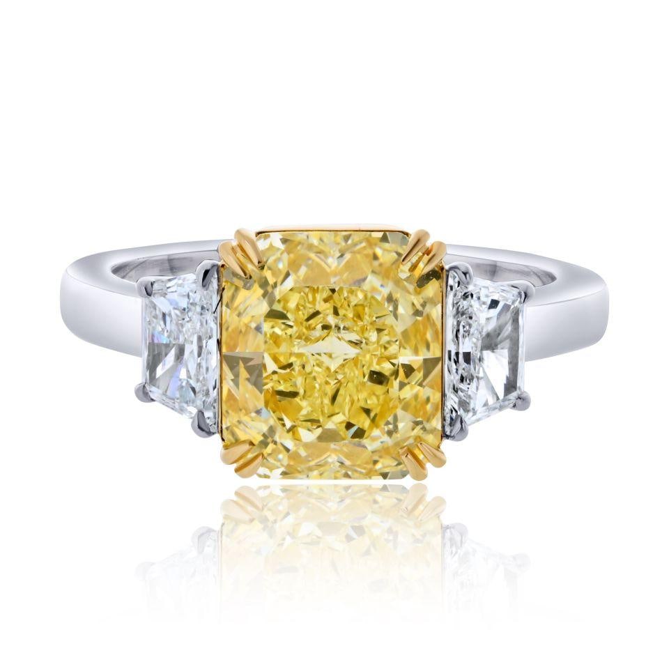 3.02 Carat Fancy Yellow Radiant Cut Diamond D/VS Platinum 18K Yellow Gold Ring: 3.02 Carat Fancy Yellow Radiant Cut Diamond D/VS Platinum 18K Yellow Gold Ring This exquisite ring features a stunning 3.02 carat radiant cut diamond in a fancy yellow hue, certified by GIA. The diamo