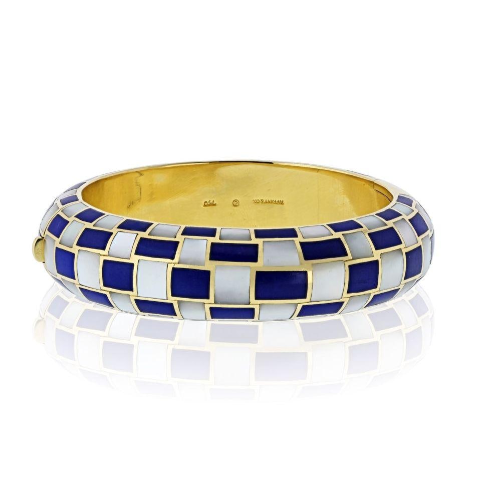 Angela Cummings Tiffany 18K Gold Bangle with Lapis and Mother of Pearl Inlay: Angela Cummings Tiffany 18K Gold Bangle with Lapis and Mother of Pearl Inlay This Tiffany & Co. bangle bracelet, designed by Angela Cummings, is crafted from 18K yellow gold and features inlaid dyed b