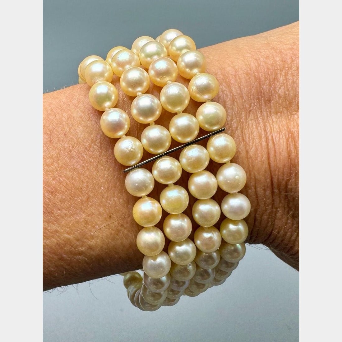 Mid Century Platinum Bracelet with Cultured Pearls and Diamonds 8 x 1 Inches: Mid Century Platinum Bracelet with Cultured Pearls and Diamonds 8 x 1 Inches Elegant 1950s bracelet crafted in platinum, featuring cultured pearls measuring between 6.5 mm and 6.6 mm. The piece is set