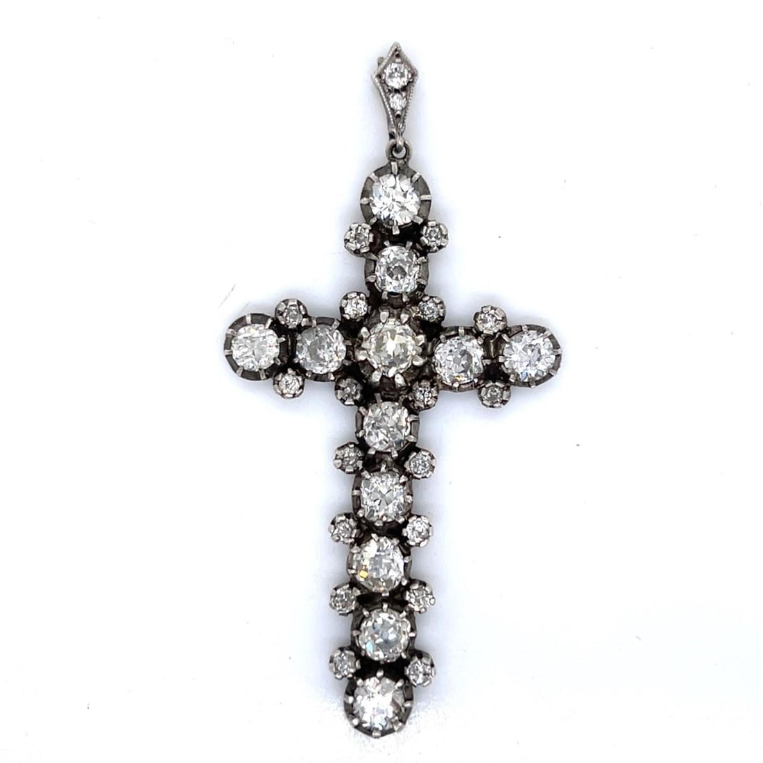 Antique 18K Silver Diamond Cross 7.80 Ct Old Mine Diamonds: Antique 18K Silver Diamond Cross 7.80 Ct Old Mine Diamonds This exquisite Antique Cross combines the elegance of 18K gold and silver with a stunning array of diamonds. Weighing 9.5 grams, it features