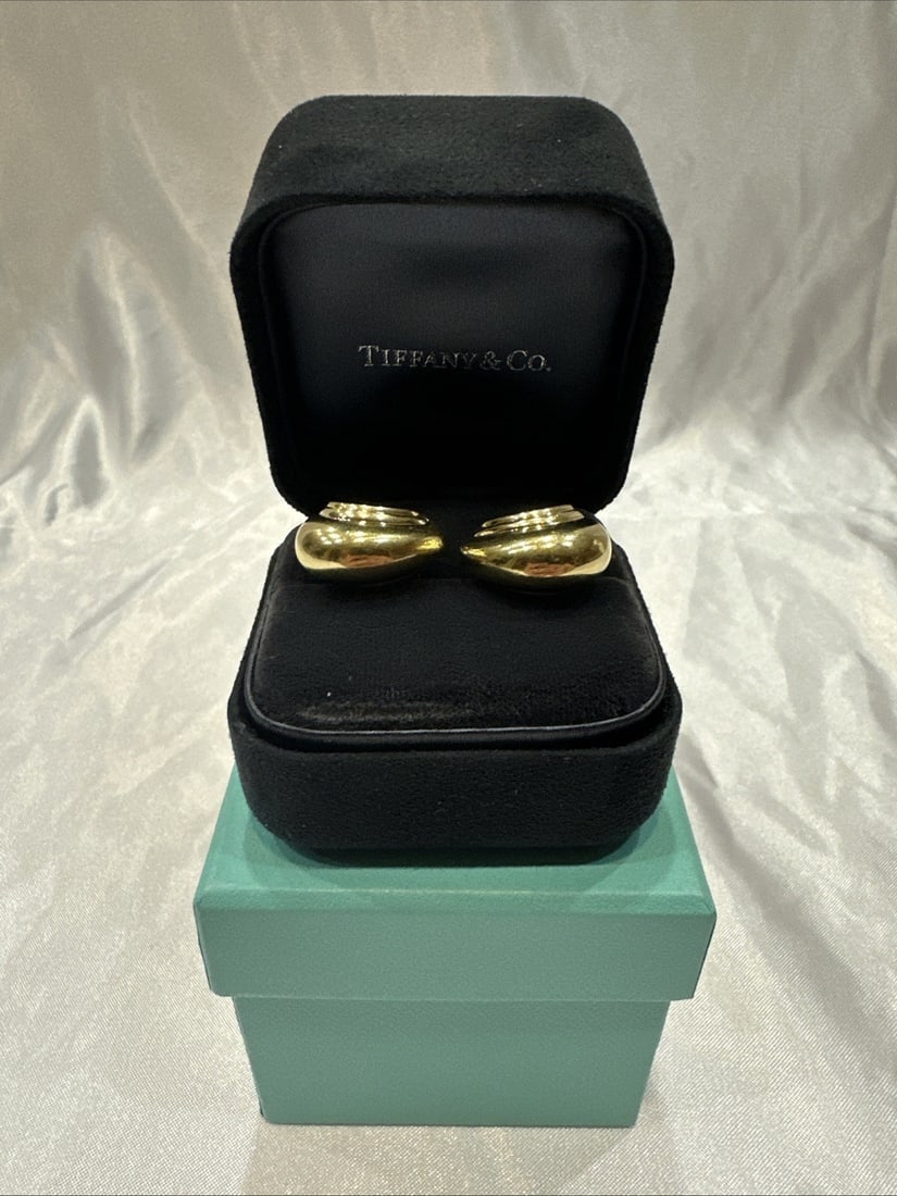 Tiffany & Co 18K Yellow Gold Cuff Huggie Earrings with Box: Tiffany & Co 18K Yellow Gold Cuff Huggie Earrings with Box Introducing a stunning pair of Tiffany & Co. earrings crafted from luxurious 18k yellow gold. These cuff huggie earrings are not only elegant