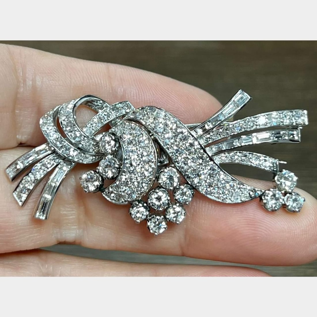Art Deco Platinum 6.60 Ct Diamond Brooch with Baguette and European-Cut Diamonds: Art Deco Platinum 6.60 Ct Diamond Brooch with Baguette and European-Cut Diamonds This exquisite Art Deco brooch is crafted in platinum and features a stunning array of diamonds. It showcases 16 baguet