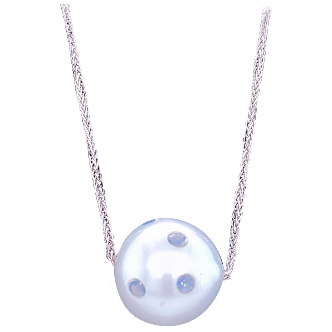 Harbor Diamonds 18K White Gold South Sea Pearl Sapphire Slide Necklace: Harbor Diamonds 18K White Gold South Sea Pearl Sapphire Slide Necklace This exquisite 18K white gold slide necklace showcases a stunning South Sea pearl, measuring 14-15 mm. The piece is adorned with