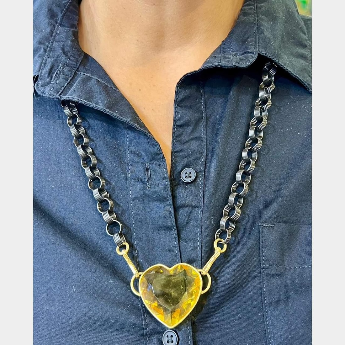 18K Yellow Gold Ionized Steel 70 Ct Heart Citrine Necklace: 18K Yellow Gold Ionized Steel 70 Ct Heart Citrine Necklace This stunning necklace features a combination of 18K yellow gold and ionized steel, elegantly set with an approximately 70.00 ct heart-shaped