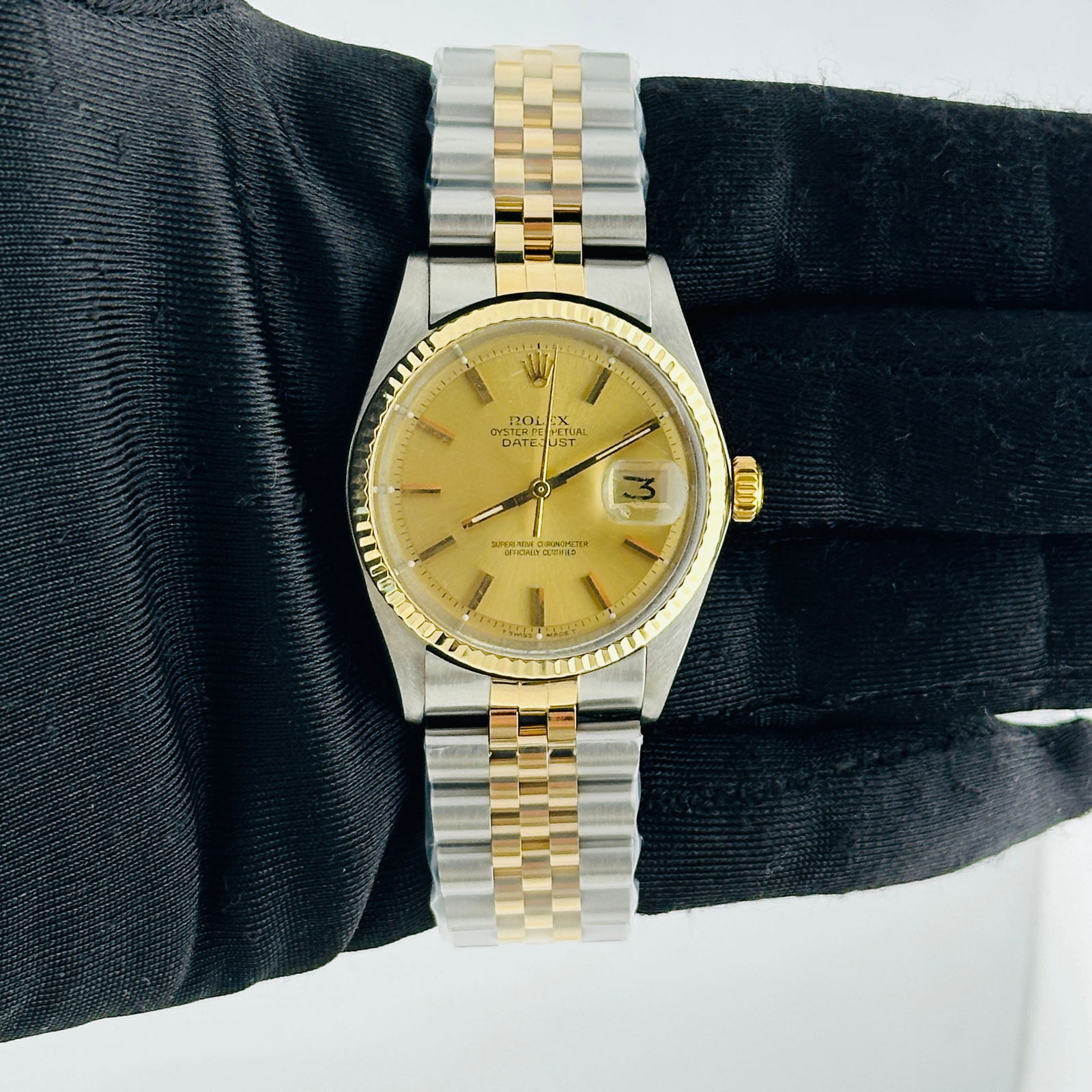 Datejust Ref 1601 Champagne Stick Dial with Aftermarket Jubilee Bracelet: Datejust Ref 1601 Champagne Stick Dial with Aftermarket Jubilee Bracelet This Rolex Datejust features a champagne stick dial, a fluted bezel, and an aftermarket Jubilee bracelet. The watch is designed