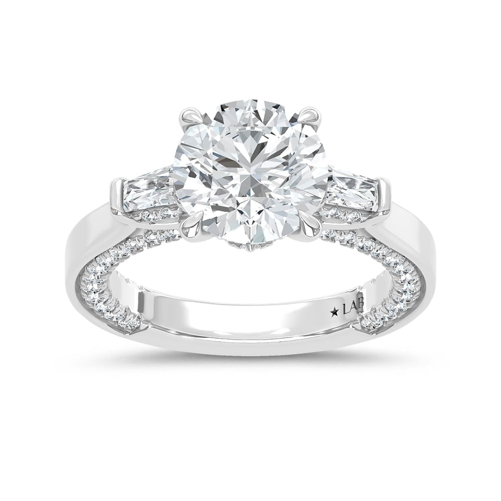14K White Gold Lab Grown Diamond 3 7/8 Ct.Tw. Oval Shape Engagement Ring: 14K White Gold Lab Grown Diamond 3 7/8 Ct.Tw. Oval Shape Engagement Ring This stunning three-stone ring features a sparkling 3 CT Oval Center diamond with two shimmering side diamonds, symbolizing pas