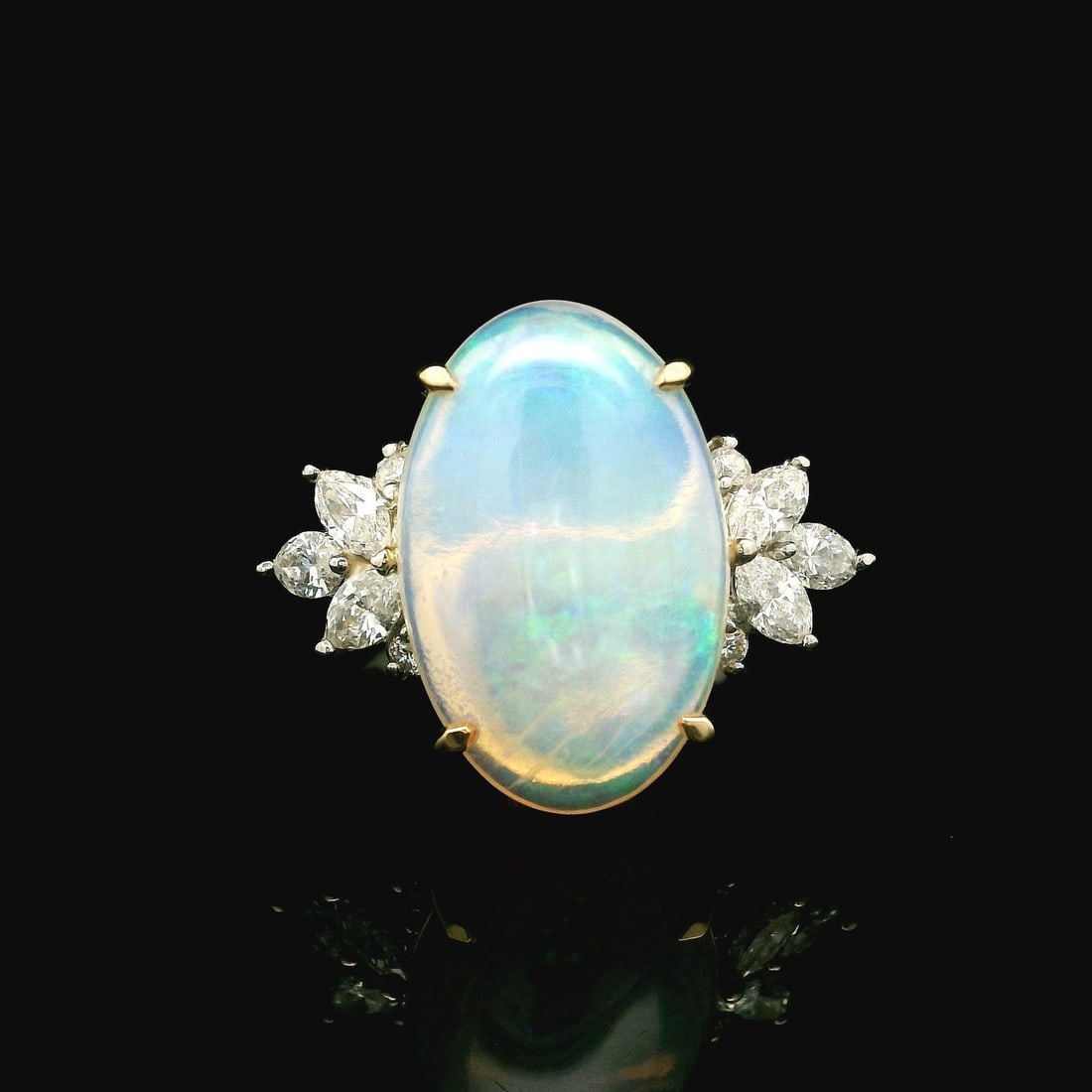 Platinum 18k Yellow Gold Oval Opal Diamond Cocktail Ring: Platinum 18k Yellow Gold Oval Opal Diamond Cocktail Ring This exquisite cocktail ring features a stunning large oval opal at its center, showcasing a captivating play of green and blue hues. The opal