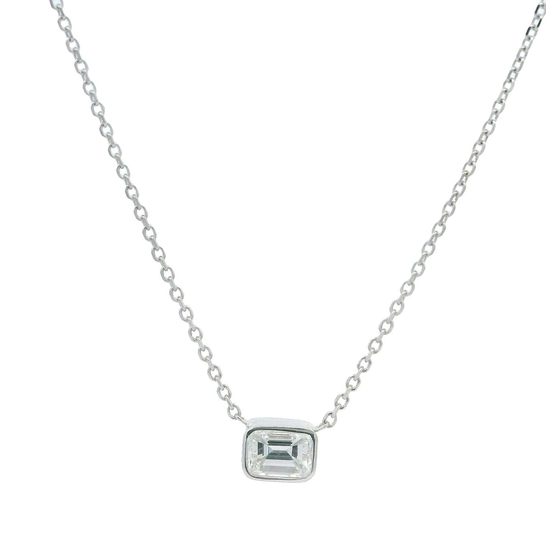14k White Gold 0.33ctw Emerald Cut Diamond Pendant Necklace: 14k White Gold 0.33ctw Emerald Cut Diamond Pendant Necklace This elegant necklace features a stunning emerald cut diamond, set in a sleek bezel, crafted from solid 14k white gold. The diamond, weighin