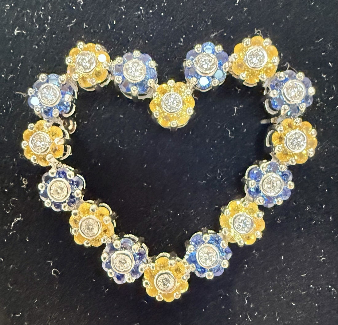 Bruno Crivelli 18K White Gold Diamond Sapphire Heart Brooch: Bruno Crivelli 18K White Gold Diamond Sapphire Heart Brooch Experience the elegance of this stunning brooch by Bruno Crivelli, crafted in 18K white gold. This exquisite piece features a heart design a