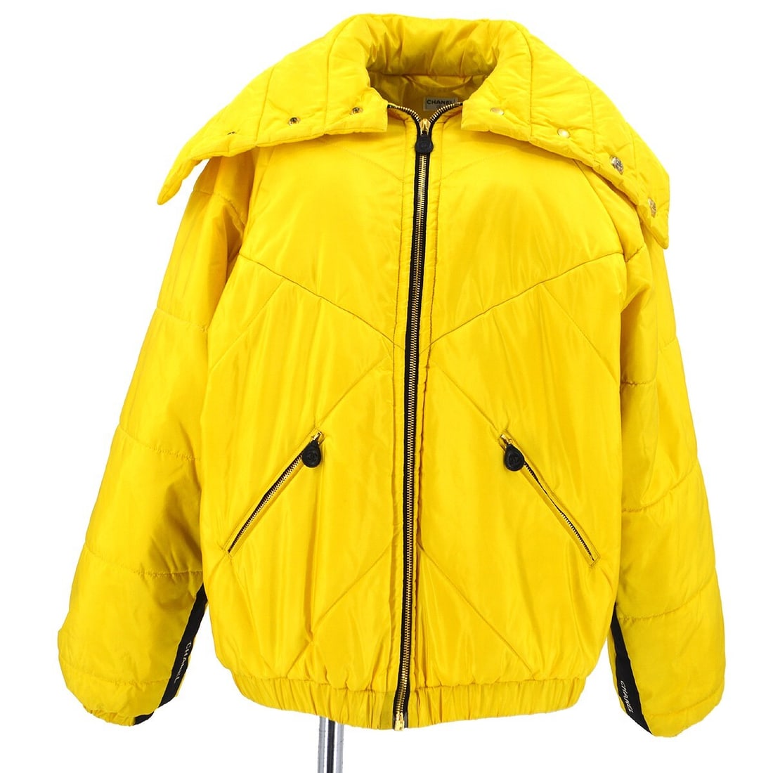 Vintage Chanel Yellow Silk Jacket with Logo Zipper: Vintage Chanel Yellow Silk Jacket with Logo Zipper This exquisite Chanel jacket is a vintage piece that combines elegance with casual style. Made from 100% silk, it features a mid-length design that i