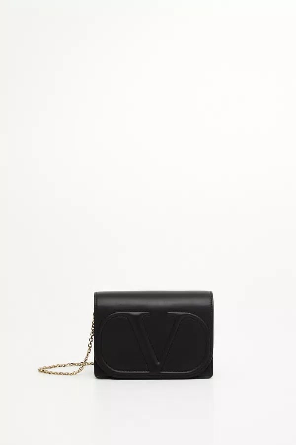 Black Leather Italian Crossbody Bag by Valentino: Black Leather Italian Crossbody Bag by Valentino This Valentino women's bag features a sleek black leather design and is crafted in Italy. The bag is un-used, with the exterior, interior, handles, cor